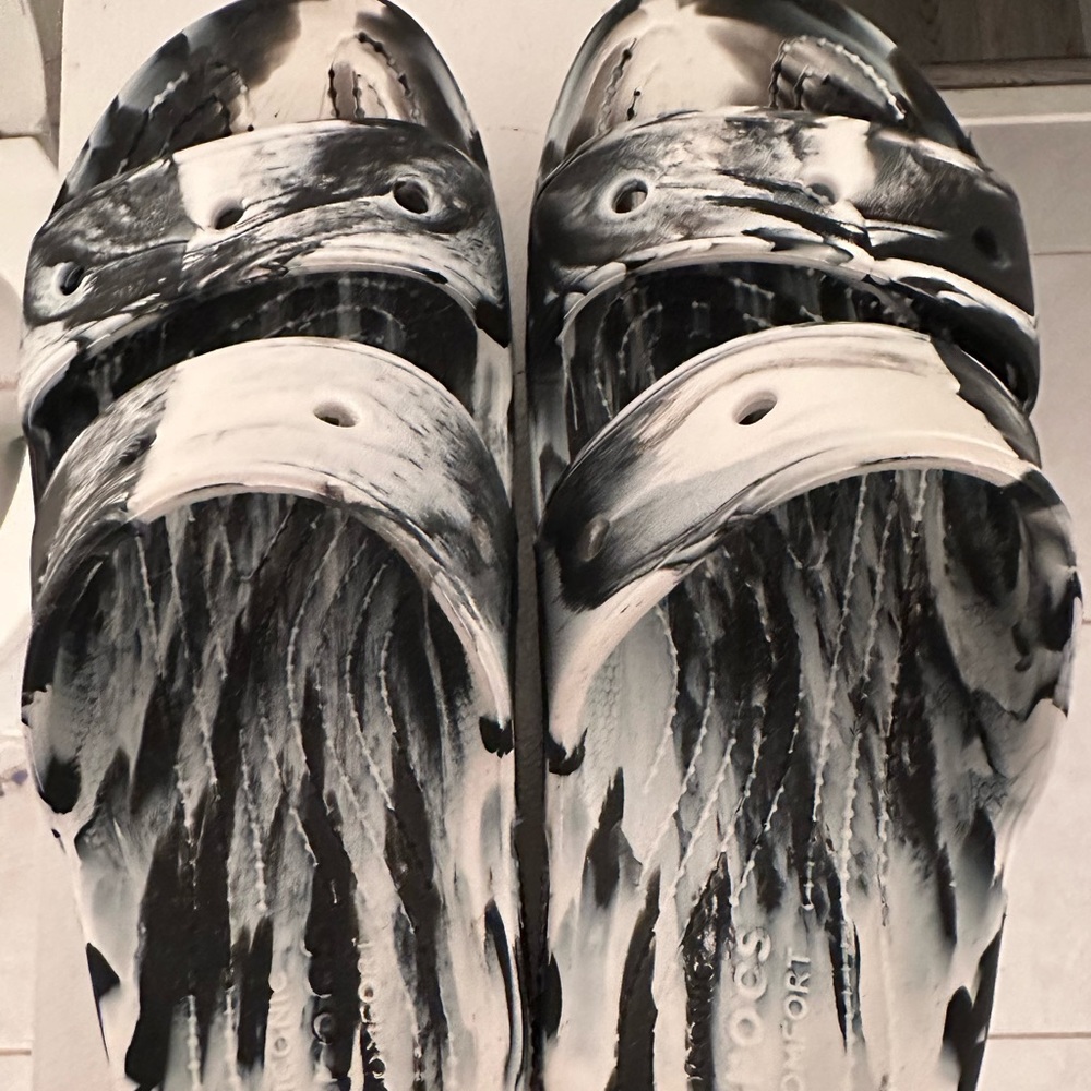 Crocs sandals black and white marble.Warn a couple of times. M size 6 W size 8.
